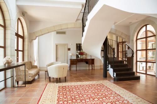 a living room with a staircase and a table at Casa Anamaria Hotel in Ollers