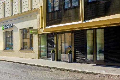 an empty street with a building with windows at H+ Hotel Wien in Vienna