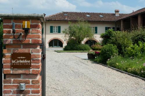 a brick gate to a house with a driveway at La Giribaldina Winery & Farmhouse in Calamandrana