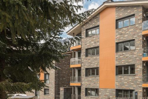 an apartment building with an orange and gray at Pierre & Vacances Andorra El Tarter in El Tarter