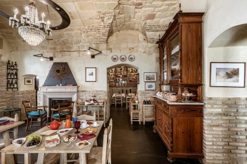 a dining room with a table and a fireplace at Palazzo Dessy in Cagliari