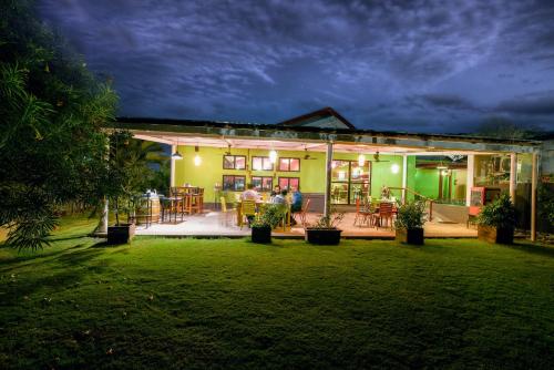 a house with people standing outside of it at night at The Source At Sula in Nashik