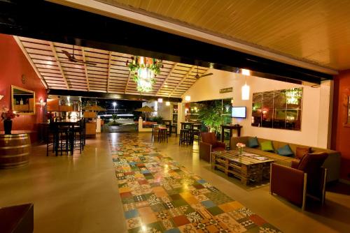 a lobby with a couch and chairs and a table at The Source At Sula in Nashik