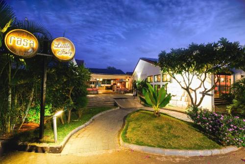 a hotel with a sign in front of a building at The Source At Sula in Nashik