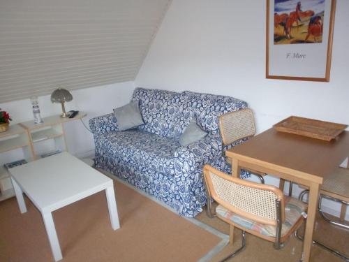 a living room with a couch and a table at Ferienwohnung-Schwalbennest in Lemkenhafen auf Fehmarn