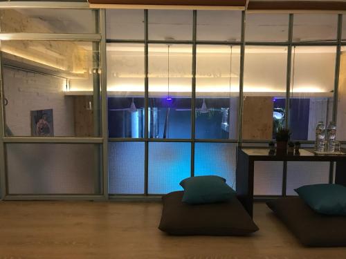 a room with a table and a large window at Blu Cabin Ari Stylish Gay Poshtel in Bangkok