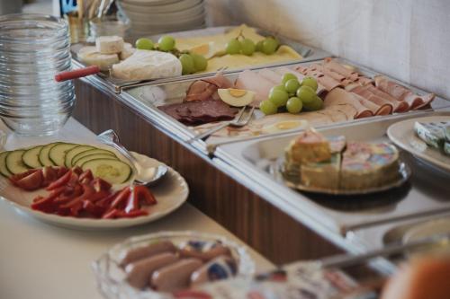 a buffet filled with different types of food on plates at Villa zur schönen Aussicht in Bad Salzuflen