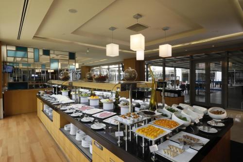 a buffet line with many different types of food at ISG Sabiha Gökçen Airport Hotel in Istanbul
