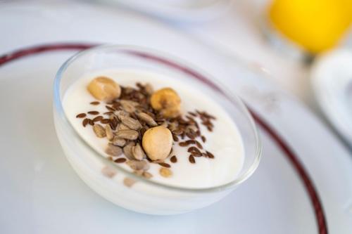 a bowl of food with nuts and seeds on a plate at Hotel Garni Sonngart in Andrian