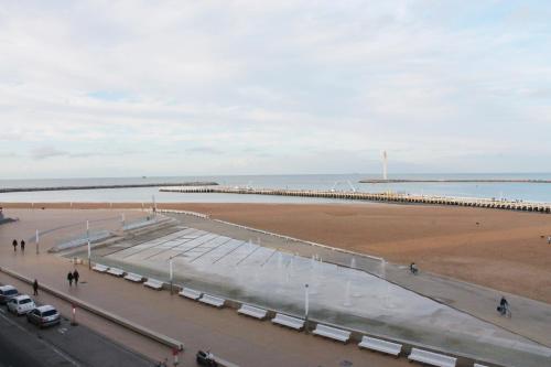 a view of a beach with a pier and the ocean at hill4 in Ostend