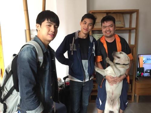 a group of three men standing with a dog at Wally House青山惠风民宿 in Zhangjiajie