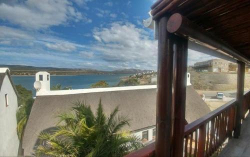 a balcony with a view of a body of water at Breede River View with mooring at Witsand,Self-Catering Apartment in Witsand