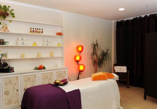 a bedroom with a bed with lights on it at Dorisol Buganvilia Studio Hotel in Funchal