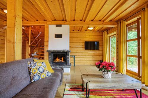 a living room with a couch and a fireplace at Chaty Mara in Liptovský Mikuláš