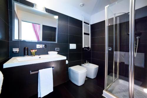 a bathroom with a sink and a toilet and a shower at Rent in Rome - IV Novembre in Rome