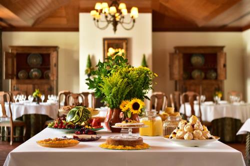 a table with a white table cloth with food on it at Pousada Convento de Vila Viçosa in Vila Viçosa