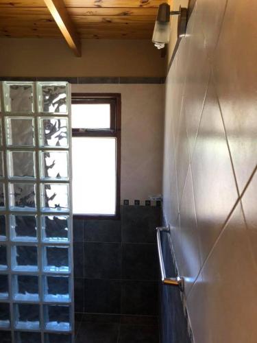 a kitchen with a bunch of wine bottles on the wall at El Viento De Mi Sueño in Tafí del Valle