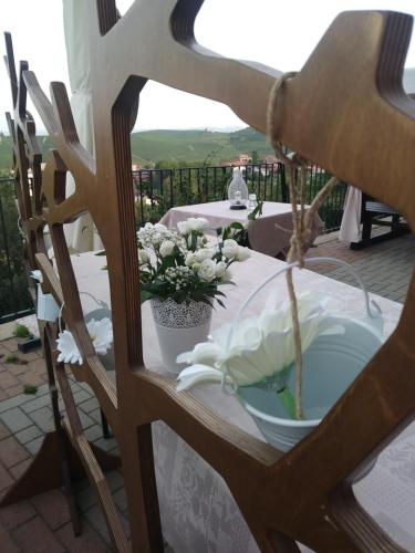 a table with a white table cloth and flowers on it at Il Borgo B&B in Castellinaldo