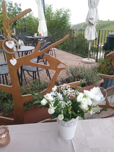 a table with white flowers on a patio at Il Borgo B&B in Castellinaldo