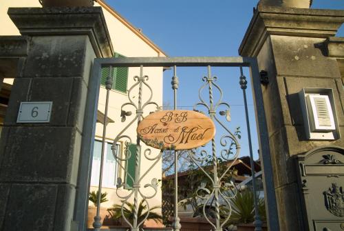 a sign on a gate in front of a building at B&B A Casa di Mael in San Costanzo