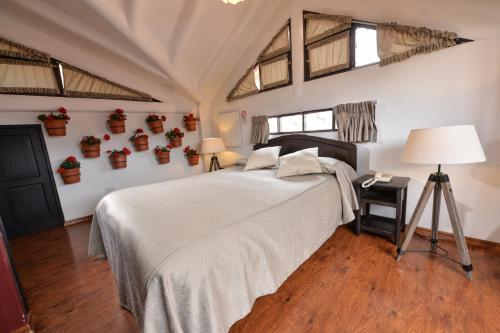 a bedroom with a bed and a table with a lamp at Tika Wasi Casa Boutique in Cusco