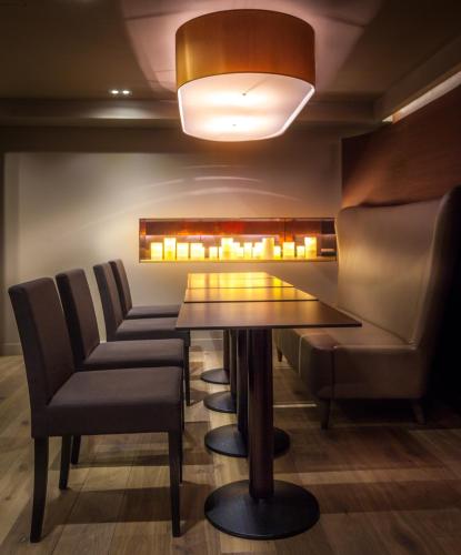 a dining room with a table and chairs at Hotel Armoni Paris in Paris