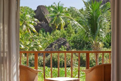 a giraffe standing on top of a balcony at Kempinski Seychelles Resort in Baie Lazare Mahé