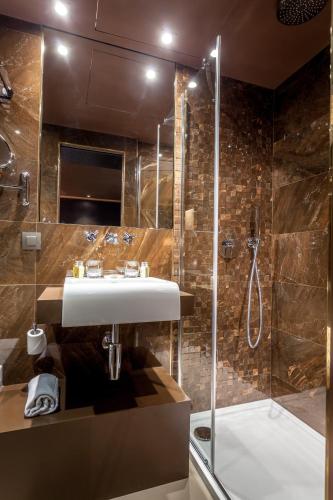 a bathroom with a sink and a shower at Hotel Armoni Paris in Paris
