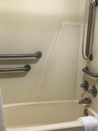 a bathroom with a shower and a bath tub at Sunrise Inn - Bradenton in Bradenton