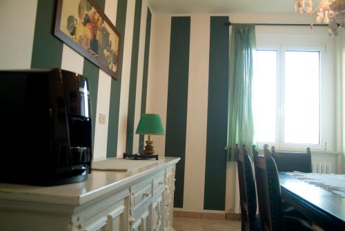 a dining room with a table and a television at B&B A Casa di Mael in San Costanzo