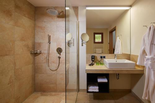 a bathroom with a sink and a shower at Landhotel Wilder Mann in Eggingen
