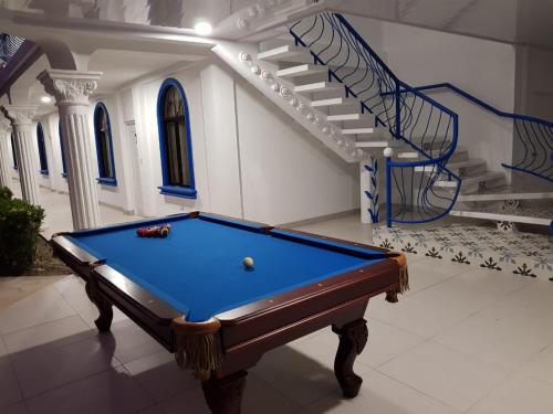 a pool table in a room with a staircase at Hotel Las Palmas de OSA in Ciudad Cortés