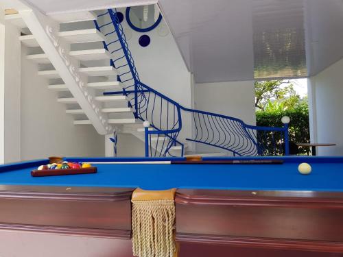 a blue pool table with a spiral stair case at Hotel Las Palmas de OSA in Ciudad Cortés