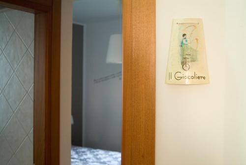 a sign on a wall with a person on a bike at B&B A Casa di Mael in San Costanzo