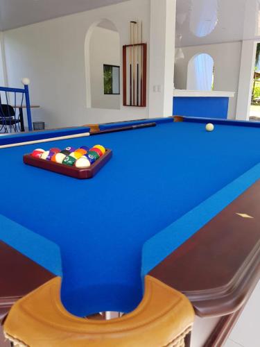 a blue pool table with balls on it at Hotel Las Palmas de OSA in Ciudad Cortés