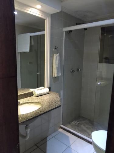a bathroom with a sink and a shower at Hotel Pousada Laje de Itauna in Saquarema