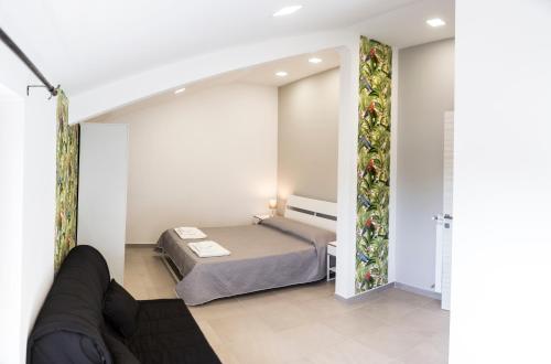 a bedroom with a bed and a couch in a room at Villa Ulivi B&B in Pontecagnano