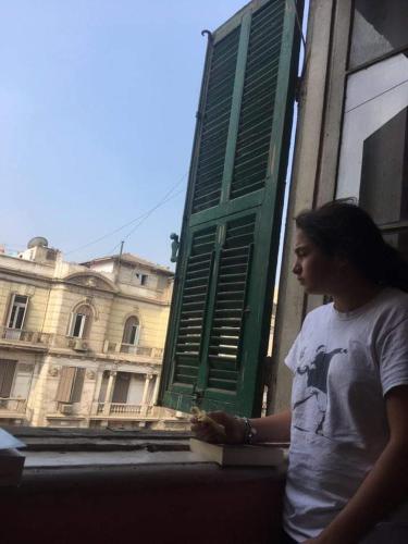 a woman standing in front of a window at Berlin Hotel in Cairo
