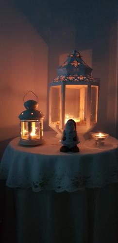 a table with two lanterns and a toy on it at Marselo B&B in Bari