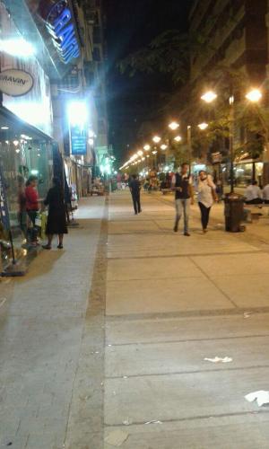 a group of people walking down a street at night at Berlin Hotel in Cairo