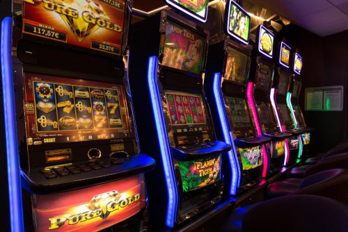 a row of slot machines in a casino at Hôtel du Béryl, Lons-le-Saunier in Lons-le-Saunier