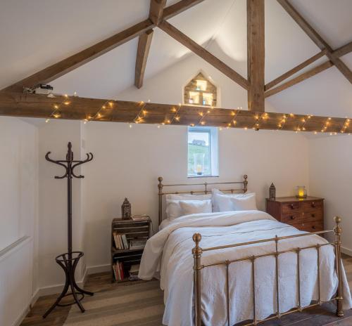 a bedroom with a bed with lights on the ceiling at The End Place in Pateley Bridge