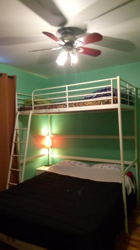 a bedroom with a bunk bed with a ceiling fan at Ottawa Backpackers Inn in Ottawa