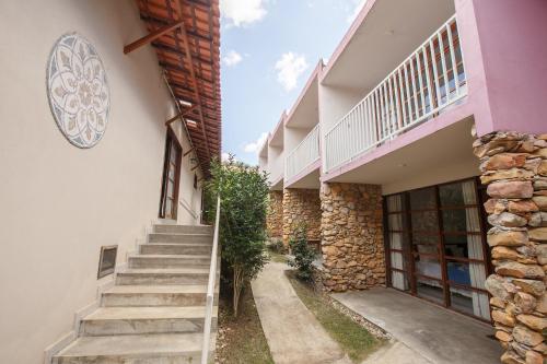 a stairway leading to a building with a stone wall at Pousada Zazen in Vale do Capao