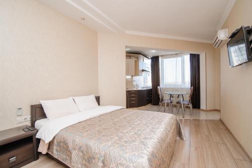 a hotel room with a bed and a table at ERA RENT Apartments in Chişinău