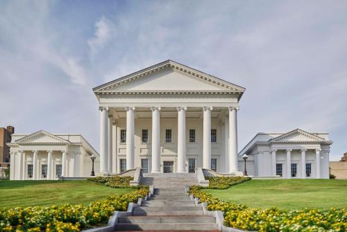 a large white building with stairs in front of it at Graduate by Hilton Richmond in Richmond