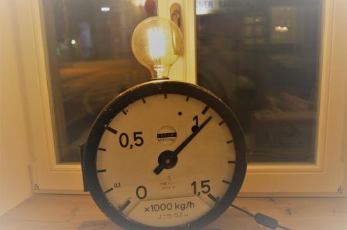 a clock sitting in front of a window at Hotel Stadtvilla Laux in Merzig