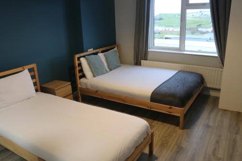 Ένα ή περισσότερα κρεβάτια σε δωμάτιο στο Rougey Lodge Hostel