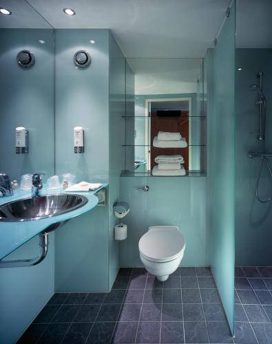 a bathroom with a toilet and a sink at Holiday Inn London West by IHG in London