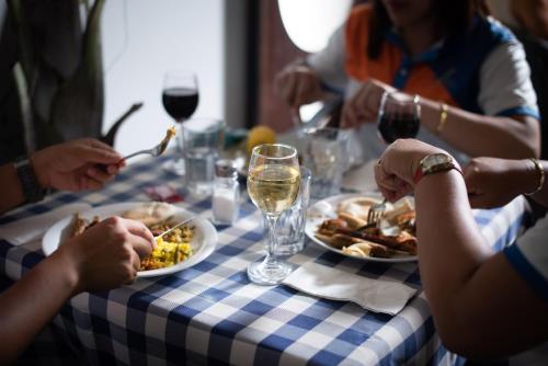 a group of people sitting around a table eating food at Astoria Galilee Hotel in Tiberias